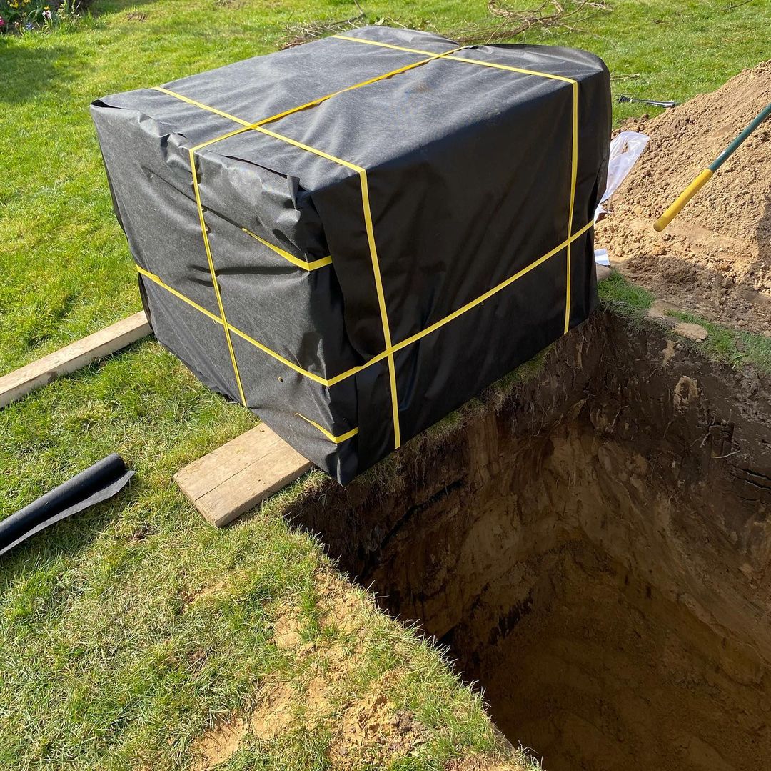 Soakaway crates installed under a block paved driveway in London